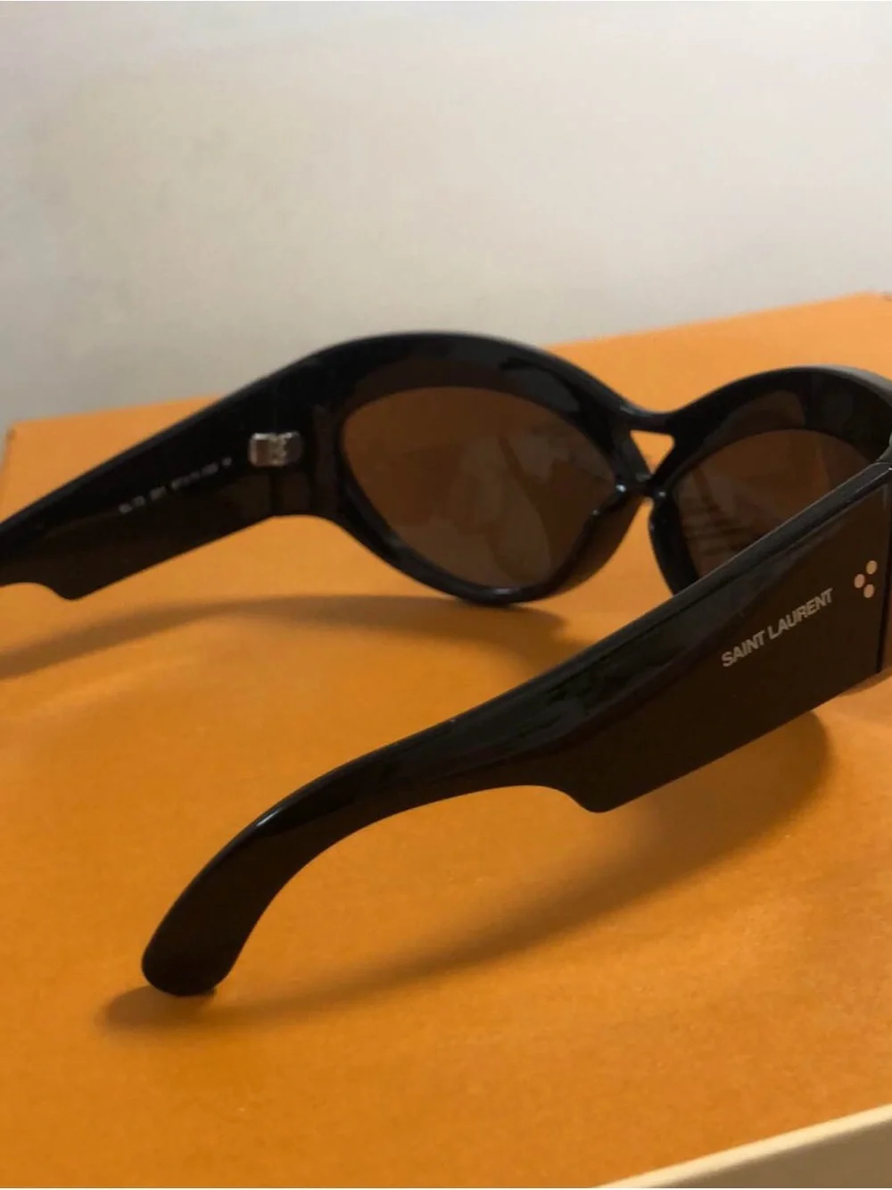 Yves Saint Laurent Black Women's Oval Sunglasses with Dark Lenses